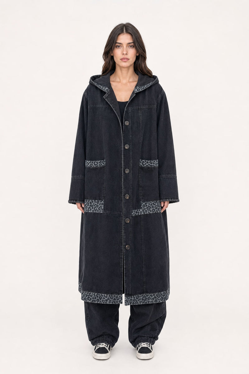 Long manteau en denim noir à capuche porté de face, coupe oversize longueur mollet